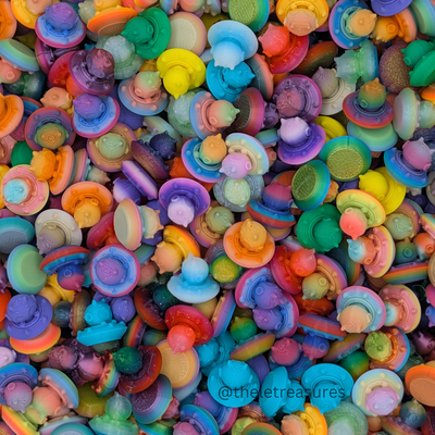 Pile of multicolor tiny alien UFO figurines – micro collectible toys